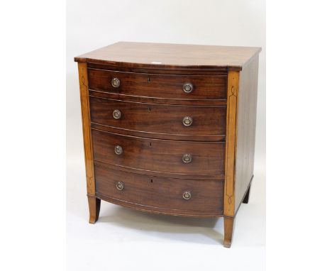 Small Regency mahogany bow front chest of four graduated drawers with brass ring handles, flanked by black line inlaid pilast