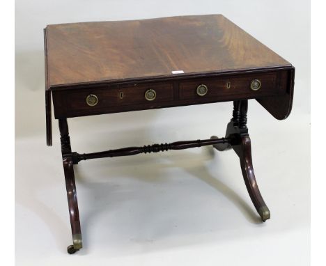 Regency mahogany and black line inlaid drop-leaf sofa table, the figured crossbanded top above two drawers with brass ring ha