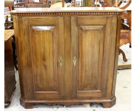 18th / 19th Century Continental walnut two door side cabinet, the moulded top above a pair of rectangular fielded panel doors