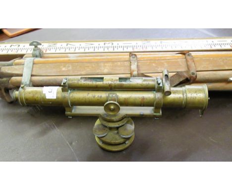 Brass surveyor's level with tripod and measuring staff 