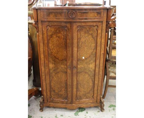 19th Century Continental figured walnut side cabinet with a single drawer above two shaped panel doors, on low cabriole suppo