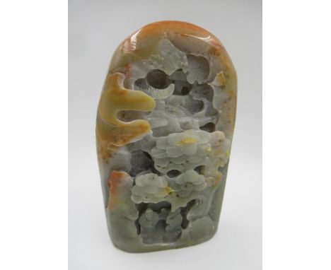 20th Century carved celadon and rust jade group of figures in a wooded landscape, 17cm high 