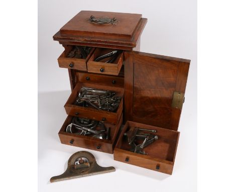 Victorian collectors cabinet, the mahogany and walnut cabinet with a door opening to reveal a series of small drawers contain