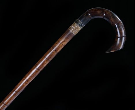 Victorian tortoiseshell walking stick, the arched handle above a stepped cane, 88cm long