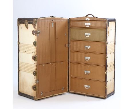 Oshkocentric steamer travel trunk, with hinged central section opening to reveal drawers to one side, the opposing side with 