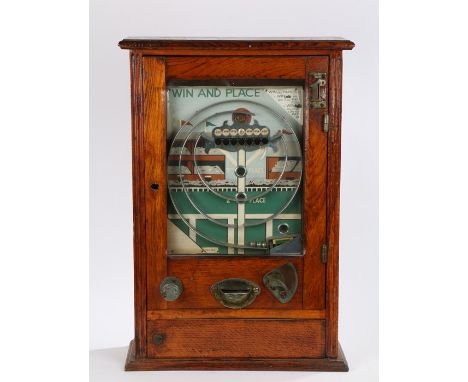 Mid 20th Century oak cased penny slot machine, the panel decorated in the form of horse racing stands with steel loop and win