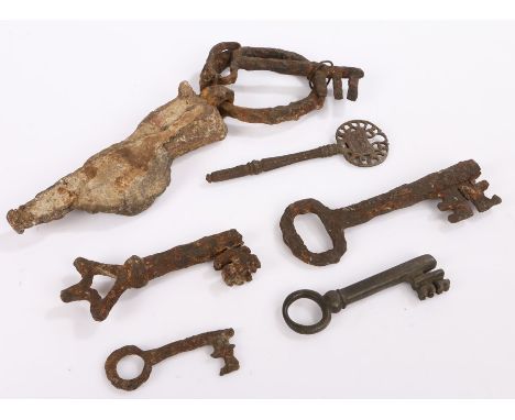 Six keys in excavated condition, one attached to a metal ring, stone and lead and with a note stating " Old key to the coffin