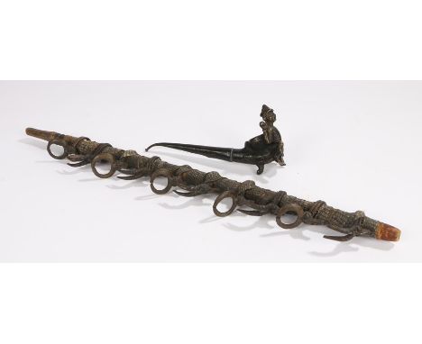 Two pipes, the first an Asian example with a crouched figure in front of the bowl, 18cm long, the second pipe with a row of s