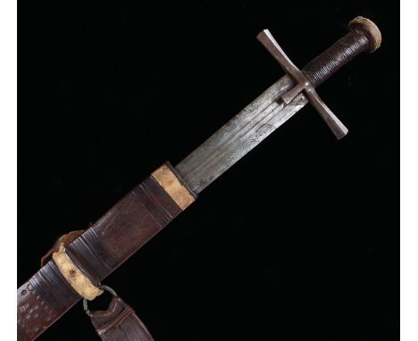 Sudanese sword, with a bund grip and steel blade decorated with half roundels complete with the  leather scabbard 