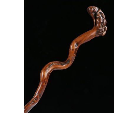 19th Century fruitwood walking stick, the winding cane carved with a snake and grapes to the grip, 86cm long