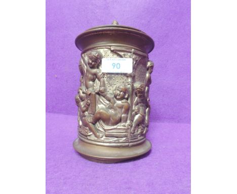 A brass tobacco jar or tea caddy, with pine cone knop and figural decoration 