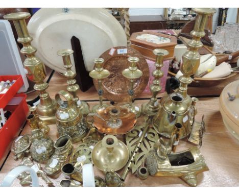 A selection of brass and copper ware including period brass candlestick, arts and craft copper plate etc