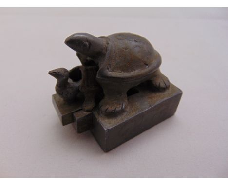 A Chinese three part metal chop seal in the form of nesting turtles