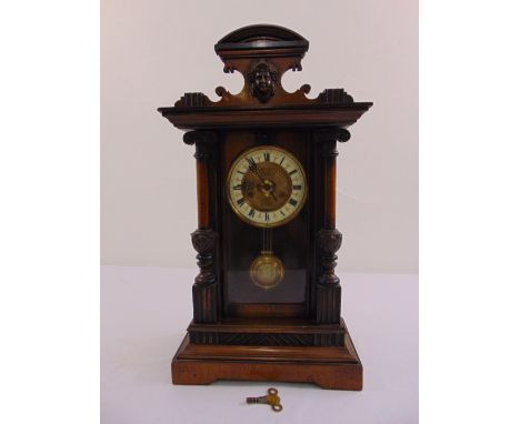 A mahogany regulator, Roman numerals to white enamel chapter ring, to include key and pendulum