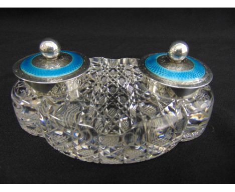 A Victorian oval cut glass ink stand with two silver and enamel inkwells, the hinged covers with ball finials, Birmingham 189