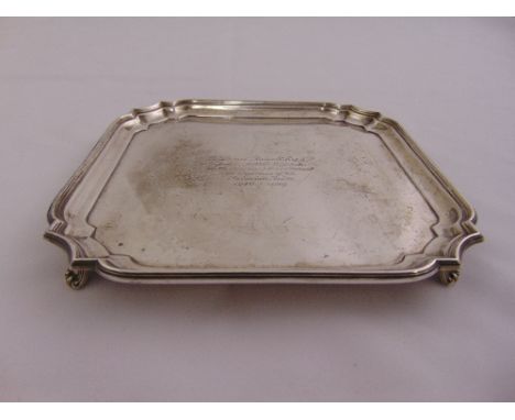 A silver presentation card tray of square form with incuse borders on four bracket feet, Sheffield 1927, approx total weight 