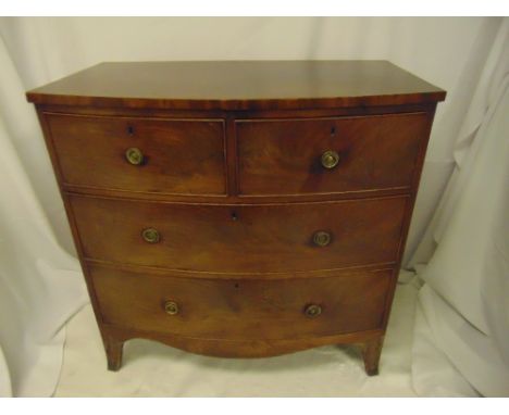 An early 19th century mahogany bow fronted chest of drawers with brass handles on four bracket feet