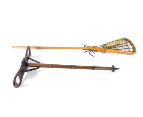 An early 20thC beech wood and black metal shooting stick, 88cm H, together with a vintage lacrosse stick, 102cm H. (2)