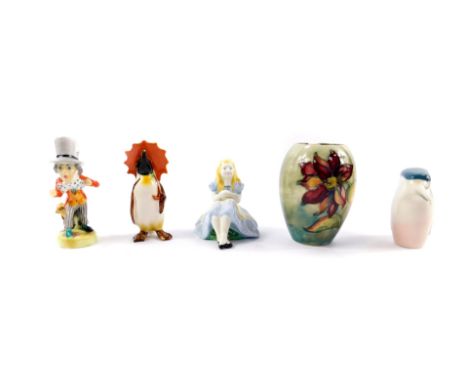 Two Alton porcelain figures modelled as Cinderella and The Mad Hatter, Beswick figure of a penguin with an orange umbrella, R