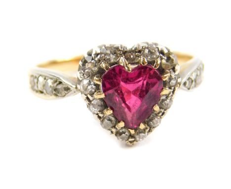 A Victorian ruby and diamond heart shaped ring, the heart shaped ruby in a surround of old cut diamonds, yellow and white met