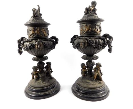 A pair of late 19thC Continental spelter urns and covers, of twin handled semi fluted form, cast with a frieze of frolicking 
