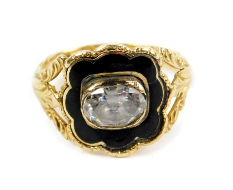 A George IV 18ct gold diamond and enamel mourning ring, set with an oval cut diamond, on an open shank with foliate engraved 