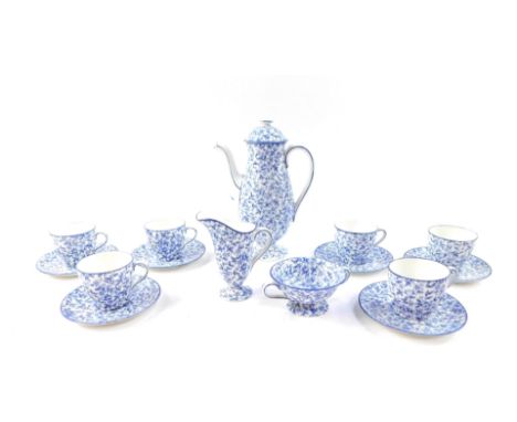 A Royal Doulton early 20thC blue and white porcelain coffee service, decorated with a floral sheet pattern, comprising coffee
