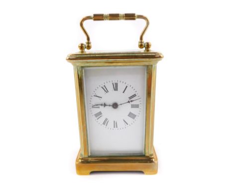 A French brass carriage clock, rectangular enamel dial bearing Roman numerals, single barrel movement, the case of plain form