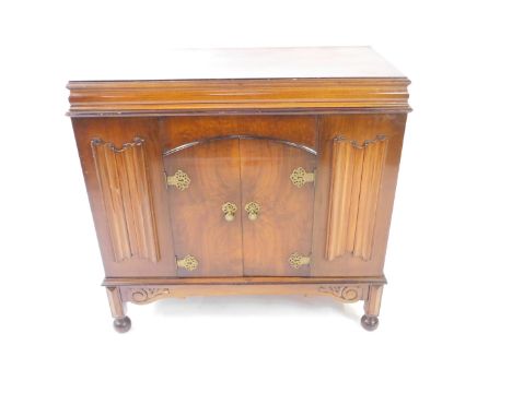 An early 20thC walnut cased cabinet gramophone, The Alba, the hinged and levered top opening to reveal a fitted interior with