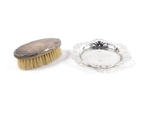 A silver dish, with a pierced outline, Birmingham 1975, 1.90oz, together with a George V silver backed hairbrush, with engine