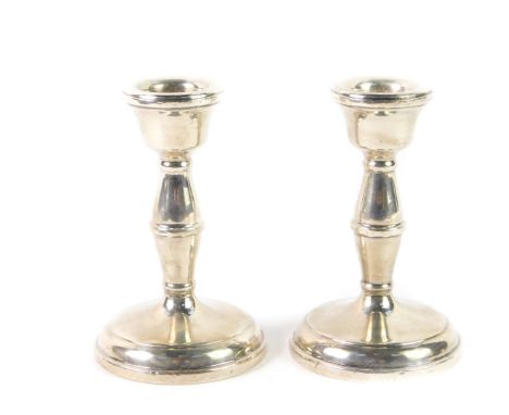 A pair of loaded silver candlesticks, of hour glass form, Birmingham 1959, 10cm H, 7.86oz all in.