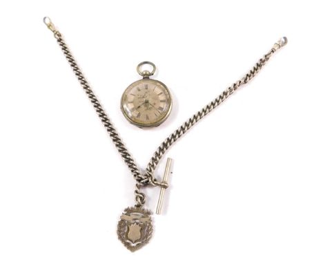 A late 19thC lady's pocket watch, open face, key wind, white metal dial with floral engraving, chapter ring bearing Roman num