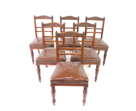 A set of six Victorian mahogany dining chairs, with foliate carved crest rail, two step ladder back, overstuffed leatherette 