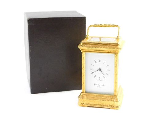 A carriage clock by Gluck &amp; Son of London, in gilt brass case with engraved foliate scroll decoration, with eight day rep