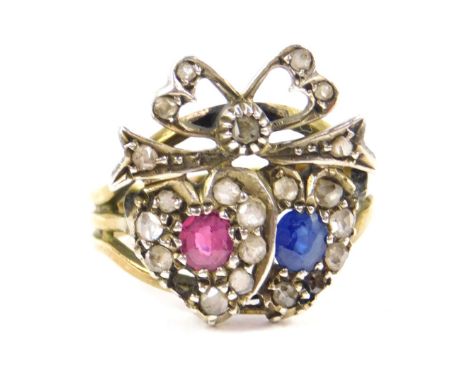 A 9ct gold diamond sapphire and ruby 'Love' ring, formed as a pair of conjoined hearts, surmounted by a bow, one diamond lack