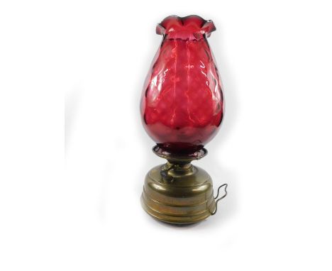 An early 20thC French Veritas Lampe brass room heater, with chimney, and ruby glass shade, 53cm H.