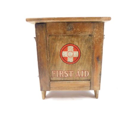 A Cuxson Gerrard &amp; Company Ltd pine first aid cabinet, with a drop down front, opening to reveal two shelves, contents ca