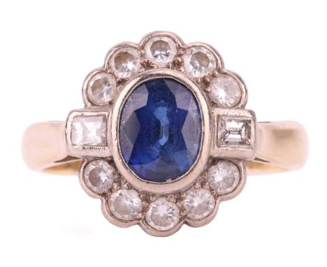 A sapphire and diamond halo ring, centred with an oval-cut sapphire of 7.4 x 6.0 mm, in a collet setting within a border of t