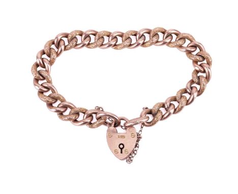 An Edwardian curb link bracelet in 9ct rose gold, link partially textured with patterns, completed with a heart-shaped padloc