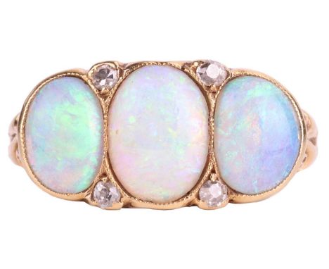 An opal and diamond-set three stone ring, the oval cabochon opals are slightly graduated with the principle opal measuring 8.