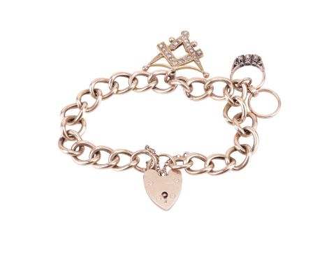 A curb link bracelet with heart padlock clasp in 9ct yellow gold, suspending with a 9ct gold charm with miniature wedding rin