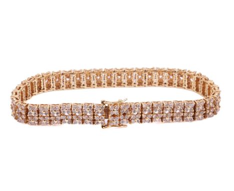 A diamond-set link bracelet in 18ct yellow gold, of floral design, comprising double rows of articulated quatrefoil links set