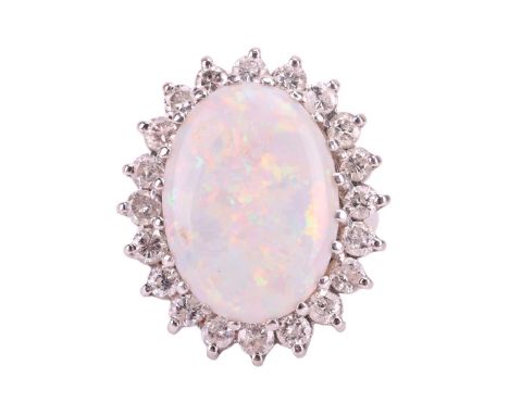 An opal and diamond cluster ring, set with a large oval white opal measuring 18.1 x 13mm, encircled by round brilliant cut di