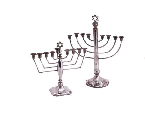 A silver menorah with curved branches and columnar stem; to an engraved domed circular base. London 1928 by Moshe Rubin, 32 c
