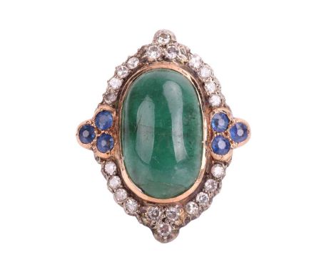 An emerald, diamond and sapphire cocktail ring, the lozenge-shaped ring head centred with a large elongated emerald cabochon 