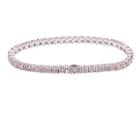 A diamond line bracelet, containing a row of 45 round brilliant-cut yellow-tinted diamonds in articulated links, with an esti