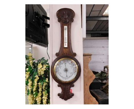 An oak cased aneroid barometer 35in high