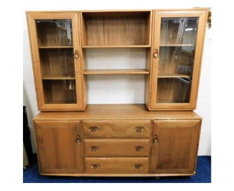 A retro styled Ercol elm wall cabinet with cupboards, shelves &amp; drawers, 63.5in high x 61in wide x 17in deep