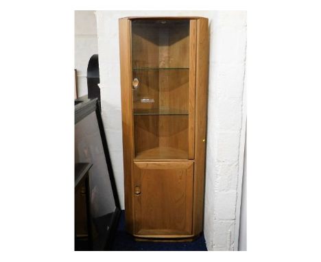 An Ercol elm corner display cabinet with lighting, 76.75in tall x 28.25in at widest x 185in deep, screw hole on inside top co