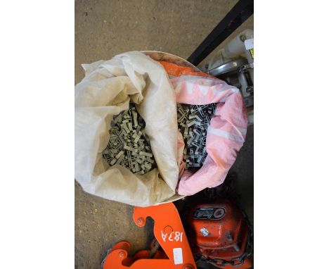 Bucket containing a large quantity of tile spacers
